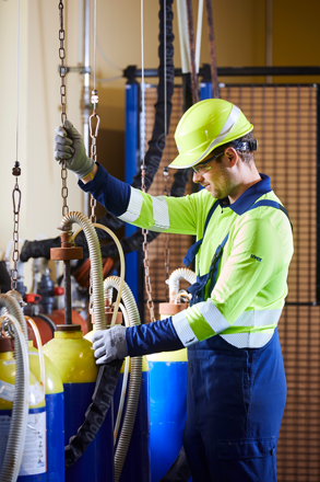 Employee checking chlorine gas cylinder